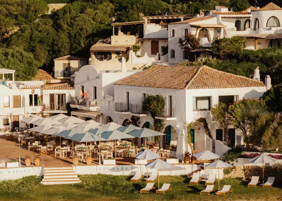 A panoramic view of Porto Rafael, showcasing a large, tranquil body of water surrounded by lush greenery.