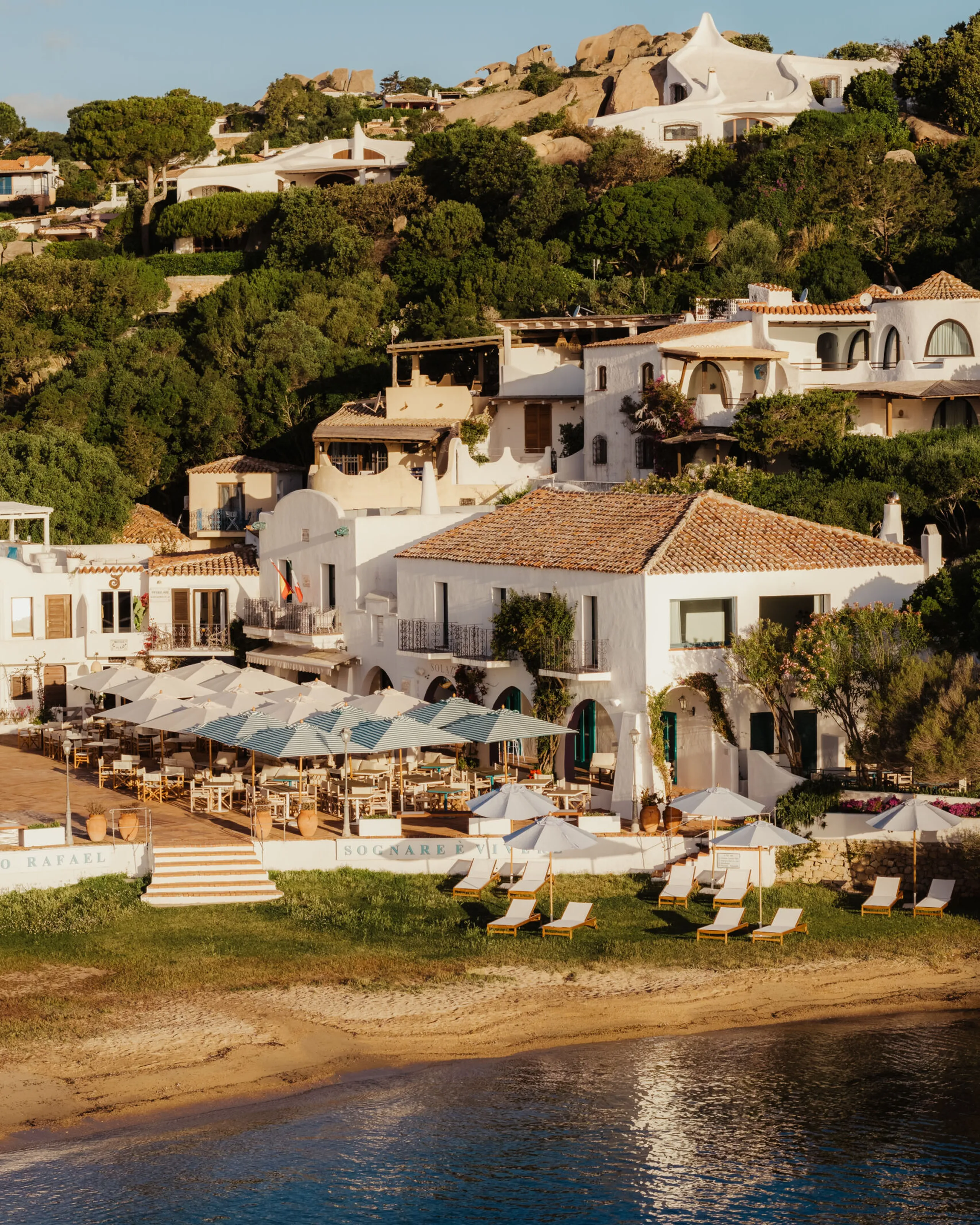 A panoramic view of Porto Rafael, showcasing a large, tranquil body of water surrounded by lush greenery.